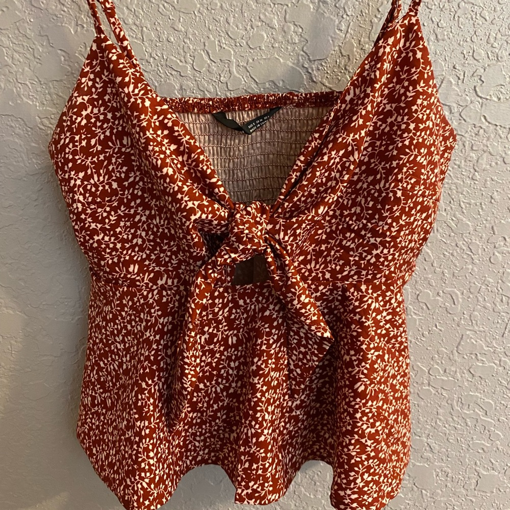 SHEIN red top with floral design.